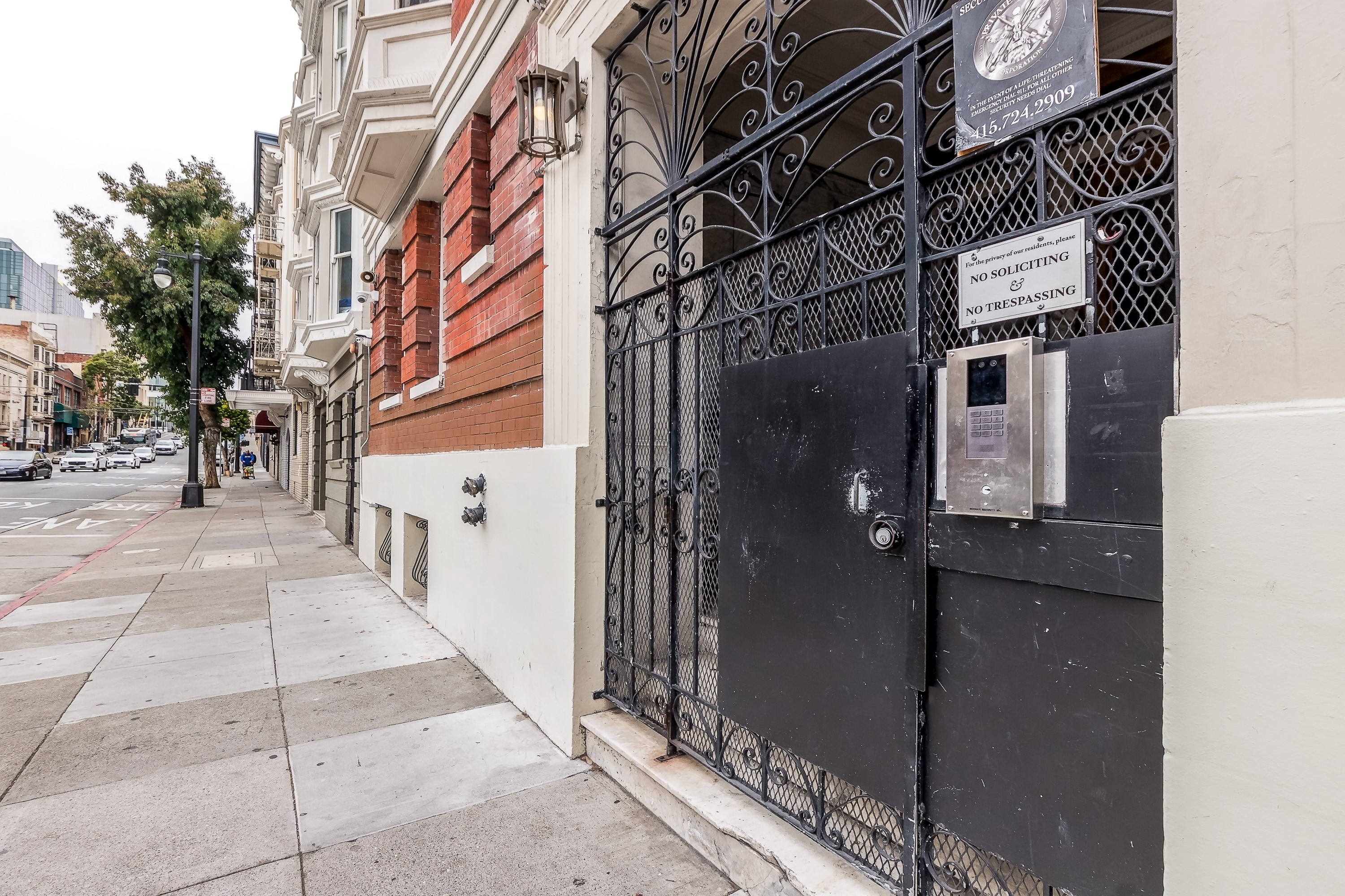 A black wrought iron gate blocks the entrance to a building.